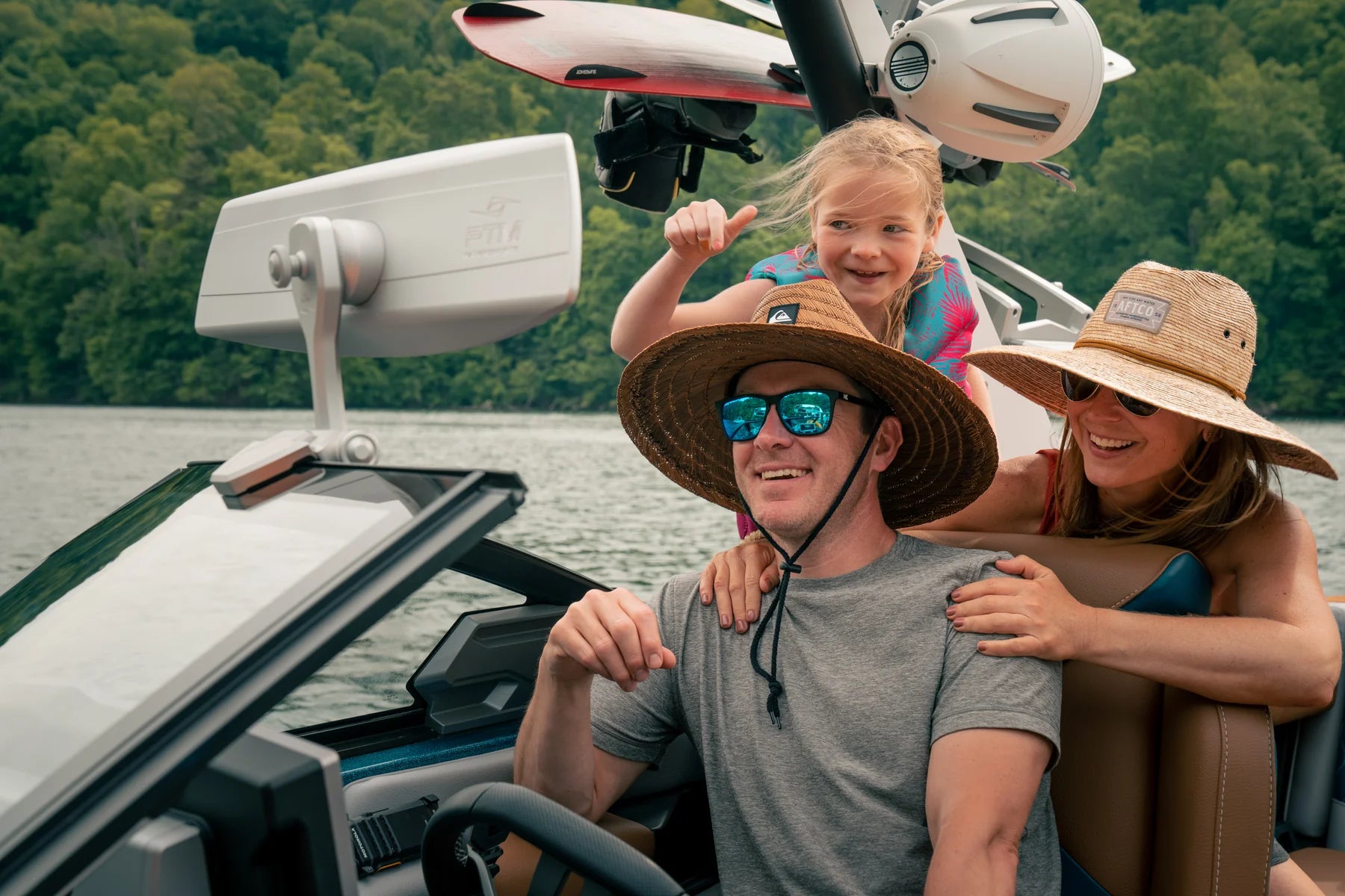 Malibu/Axis Panoramic 180 ELITE MIRROR 180, a wide-angle boat mirror, mounted on a boat with smiling family enjoying water.