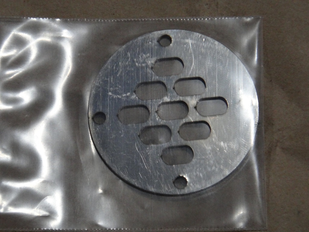 Metal Malibu floor drain cover with multiple elongated slots, designed for drainage in flooring applications.