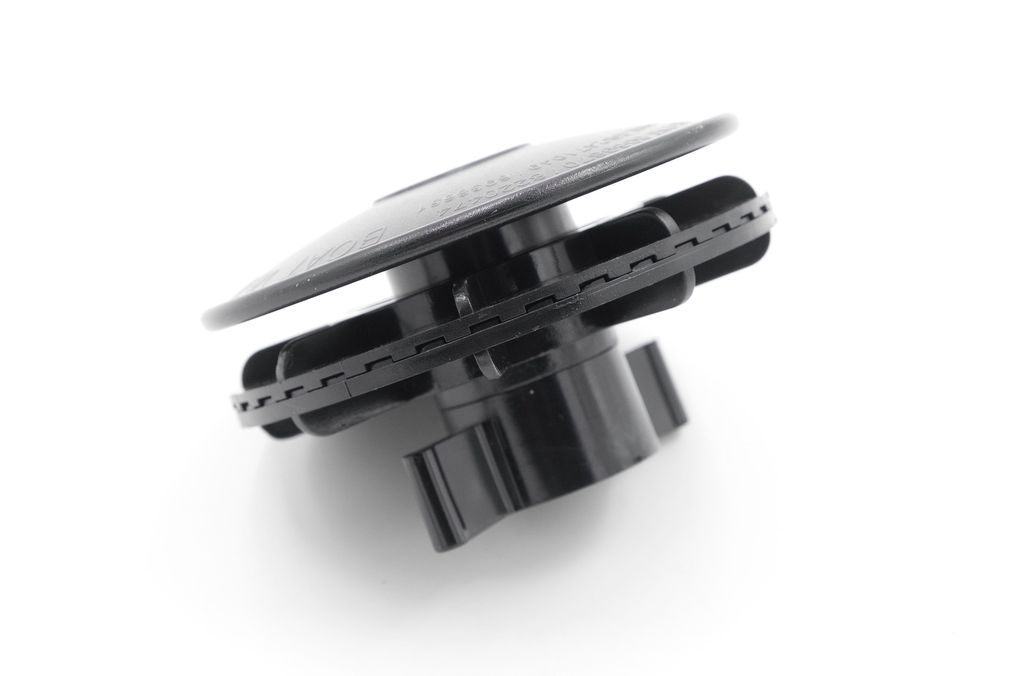 Close-up of a black cover vent with a circular design, used for ventilation or airflow regulation in appliances or systems.