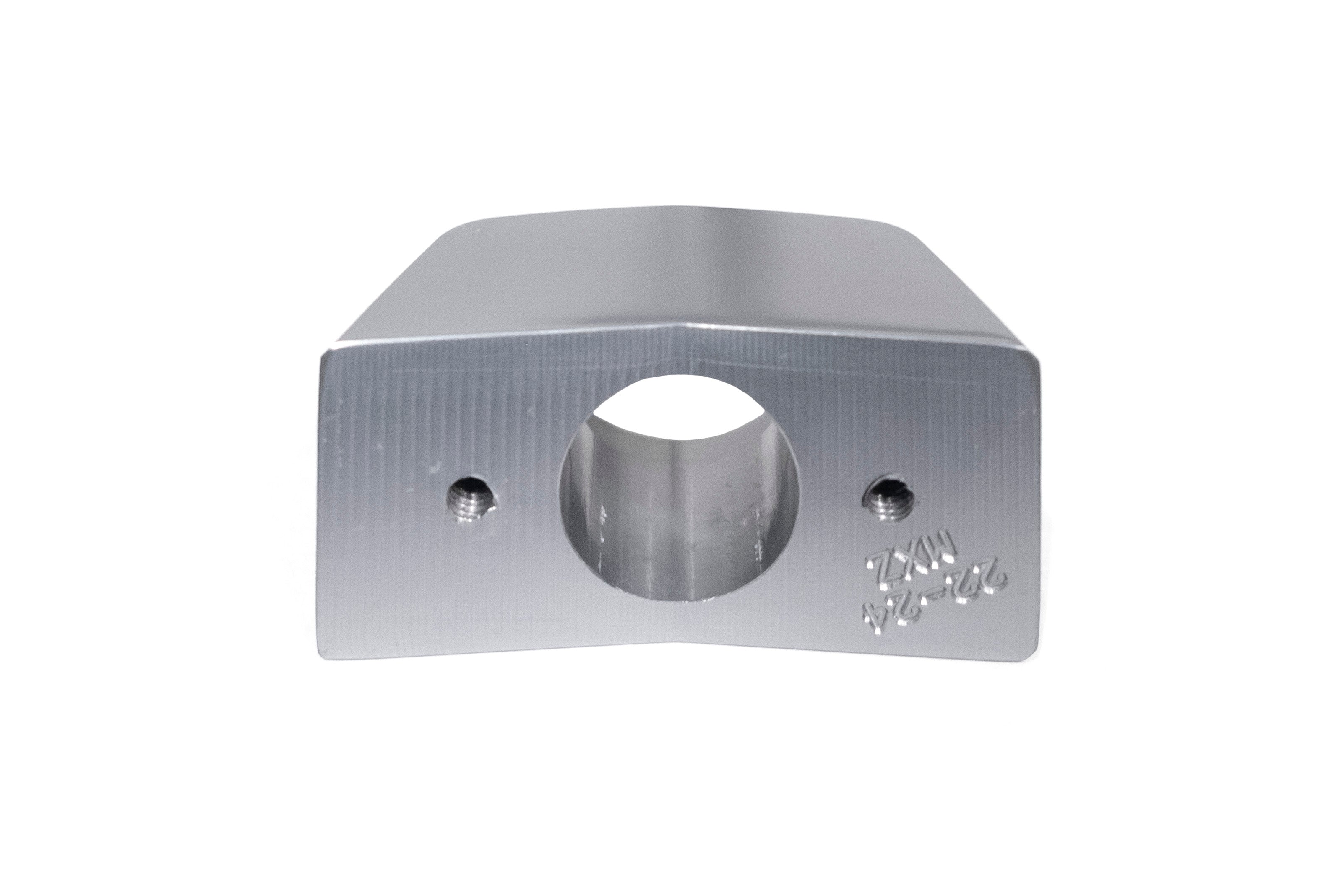 Back up camera mounting bracket for MXZ series 17- vehicles, made of metal with two screw holes and central hole.