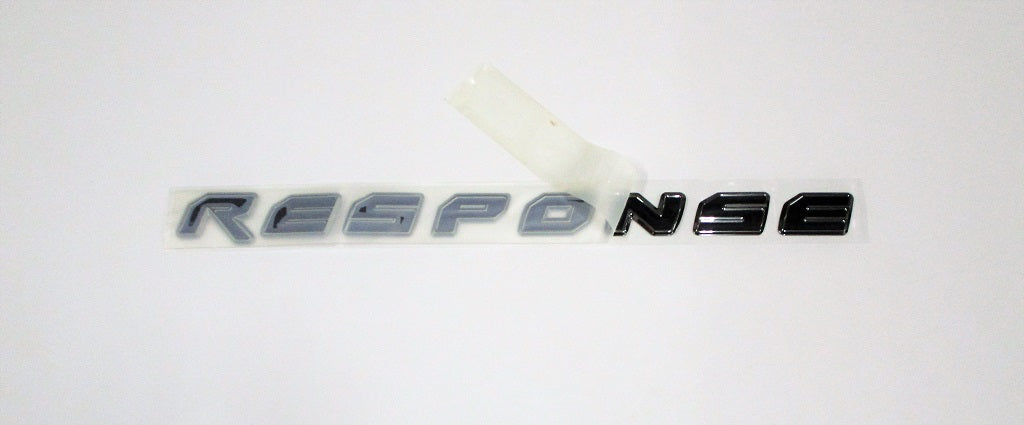 Malibu Response decal with black and silver lettering, partially covered by masking tape on a white background.