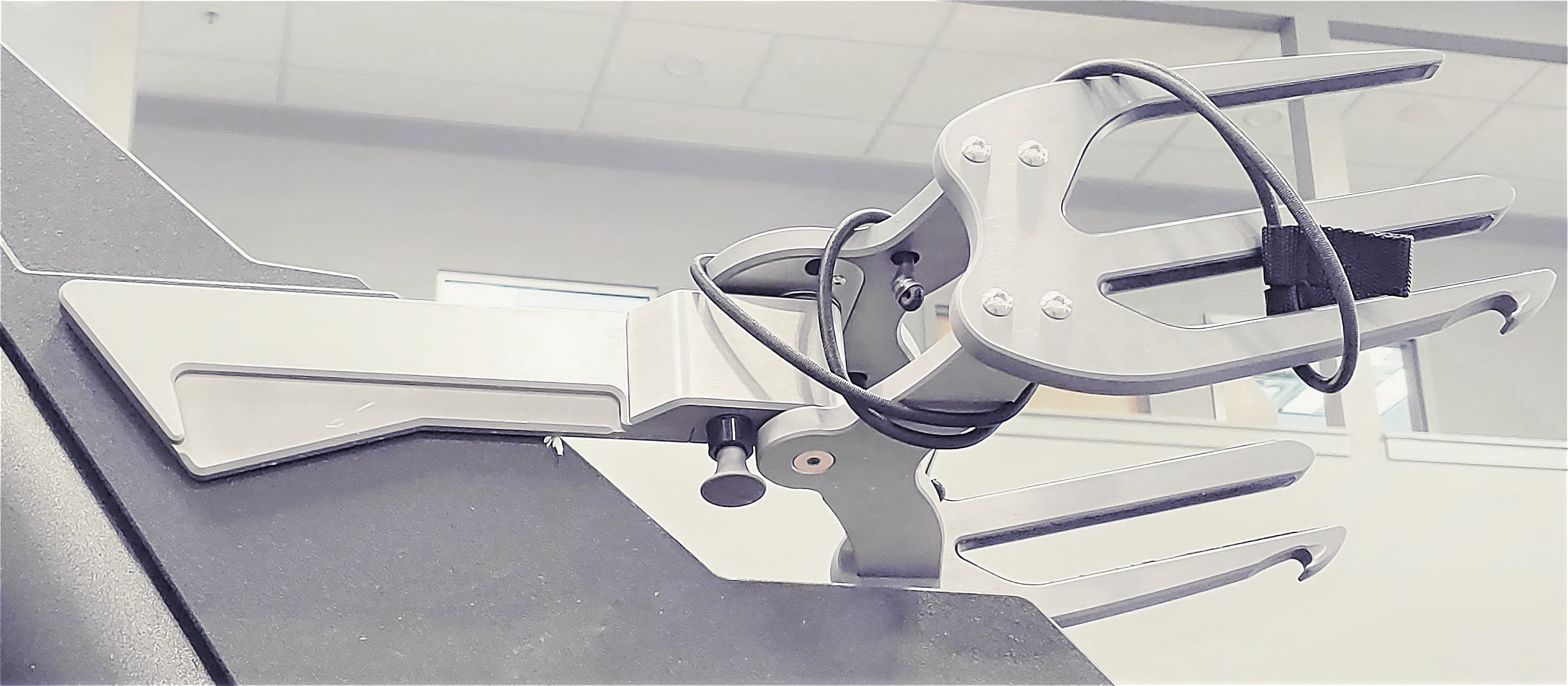 Malibu GV Spinner Racks with multiple adjustable arms, mounted on a black surface, designed for displaying or holding items.