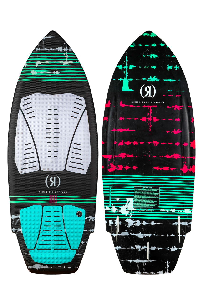 2025 Ronix Women's Koal Surface Sea Captain surfboard with black, teal, and pink design, featuring traction pads and a pointed nose.