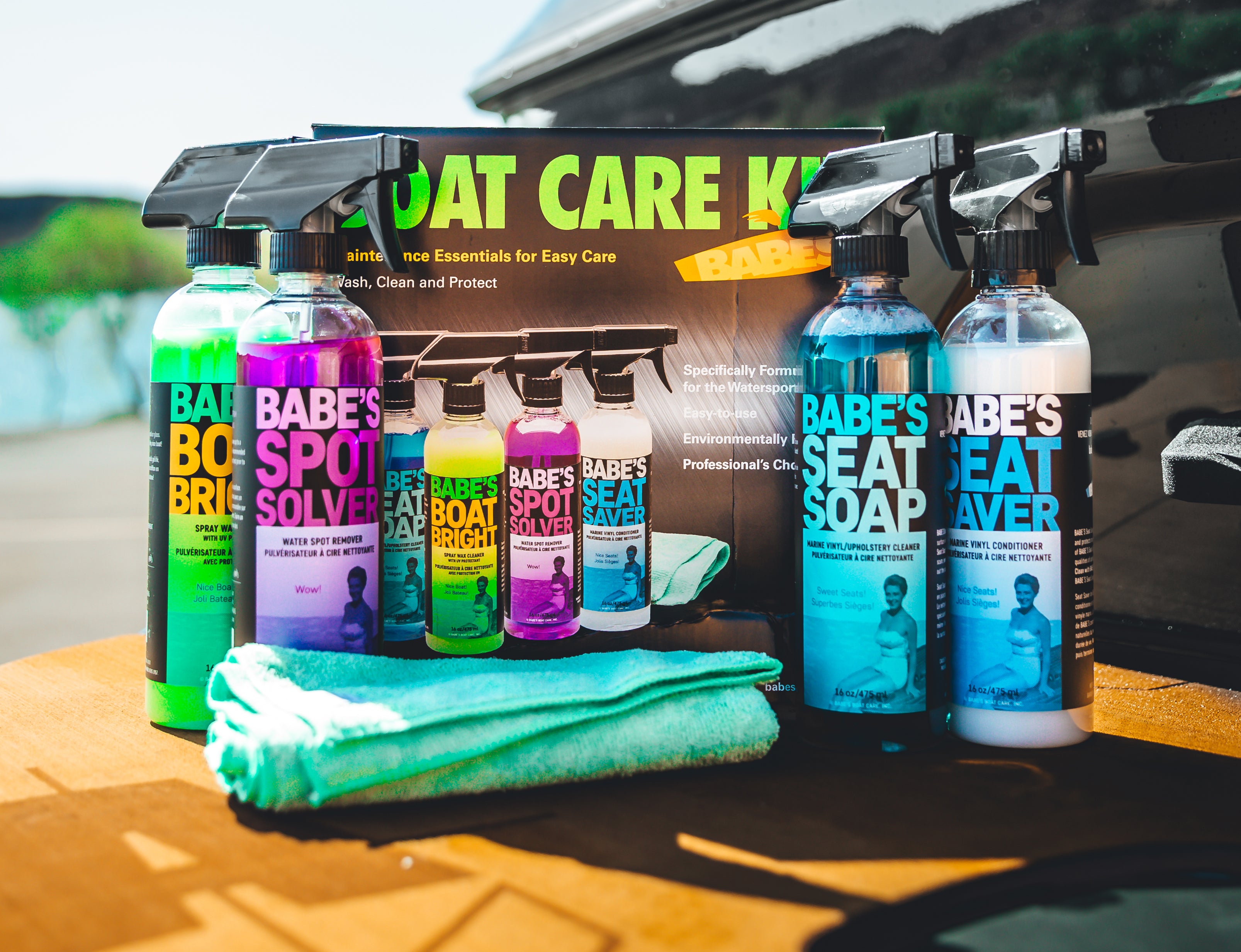 Set of Babes Boat Care Kit cleaning products, including spray bottles, towels, and a box, for boat and marine cleaning.