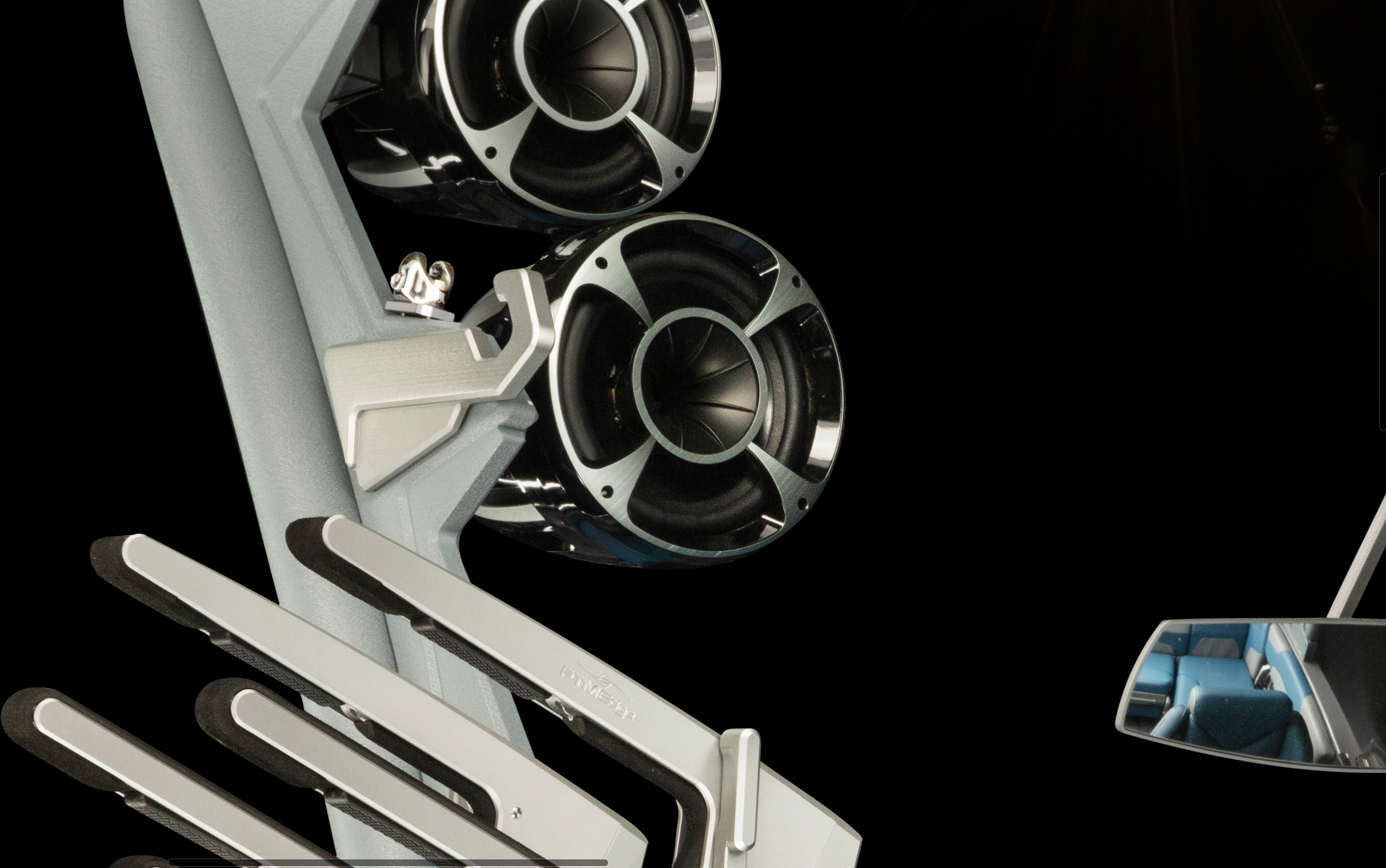 Close-up of Malibu GV Tower with surf tow hooks, featuring sleek black and chrome speakers and a modern, light-colored ski rack.