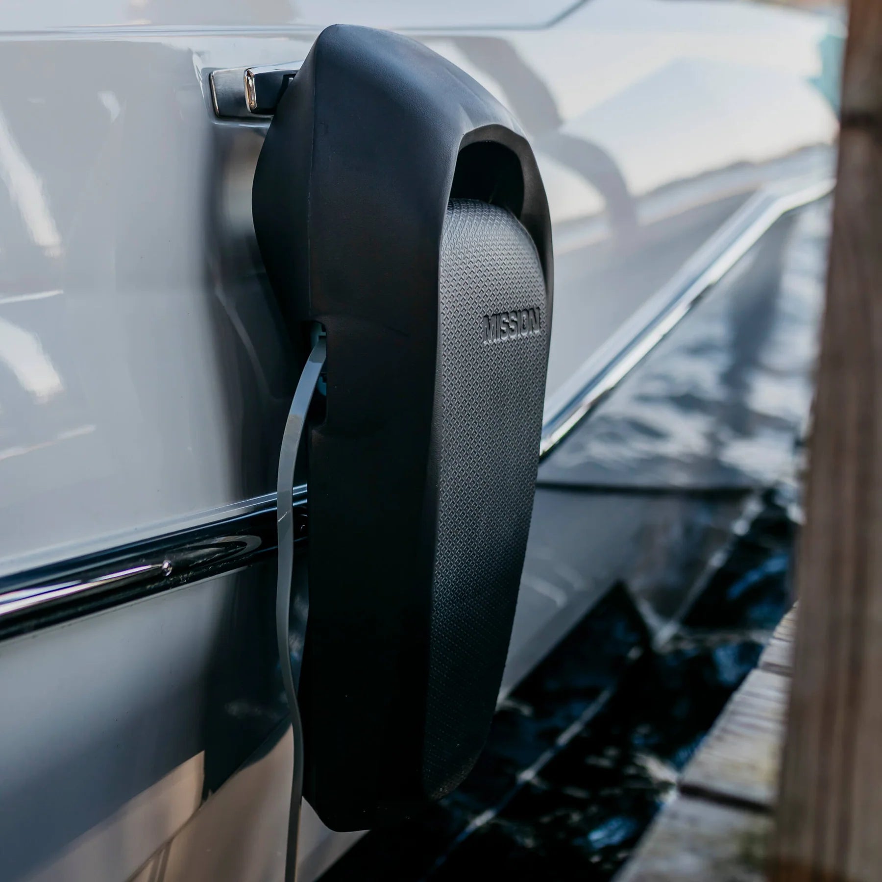 Two black Mission Boat SENTRY 2.0 boat fenders attached to a boat's side for protection during docking or mooring.
