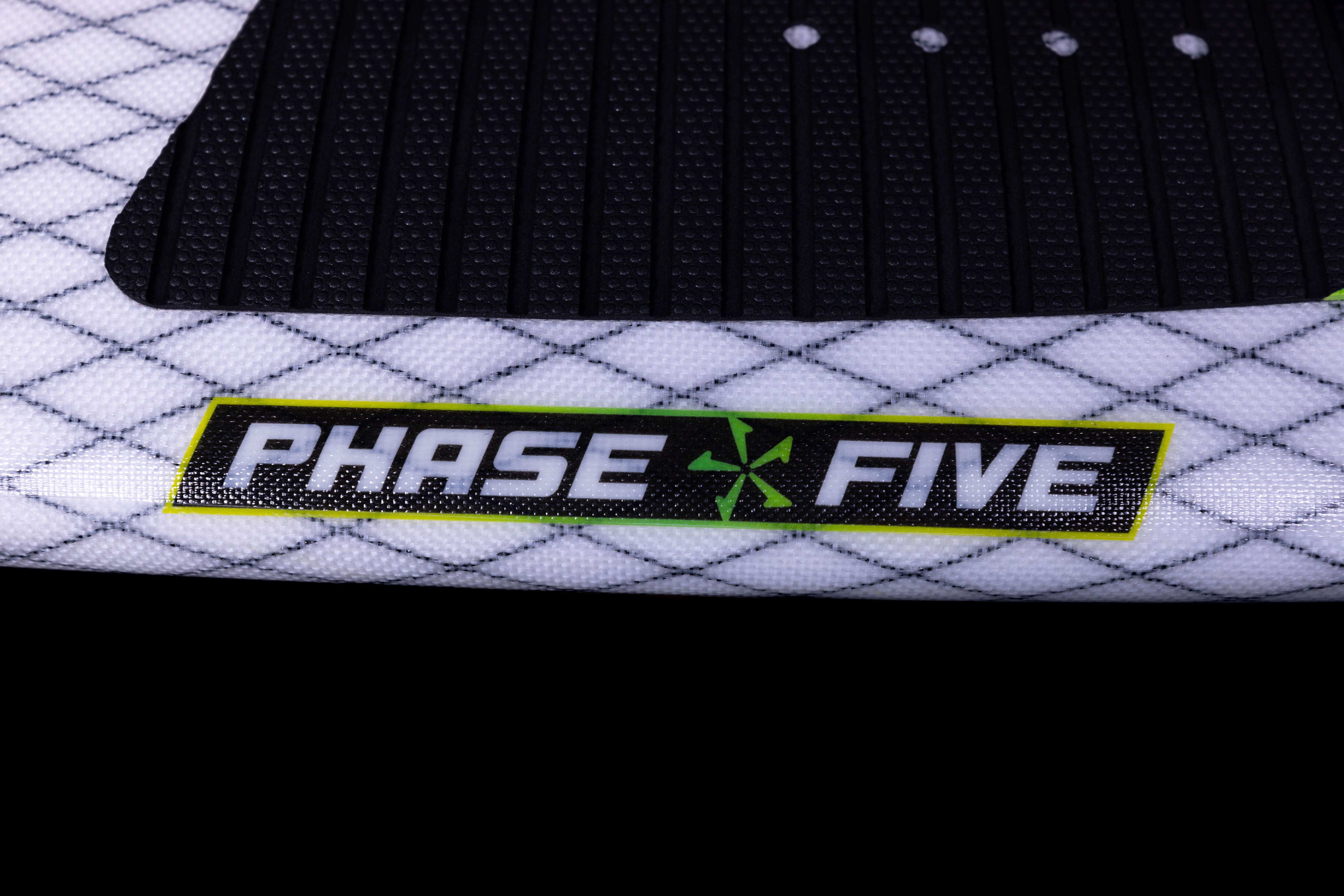 Close-up of the 2025 Phase 5 Doctor Surf Board with a black and white textured surface and a prominent "PHASE FIVE" logo in black, white, and green.