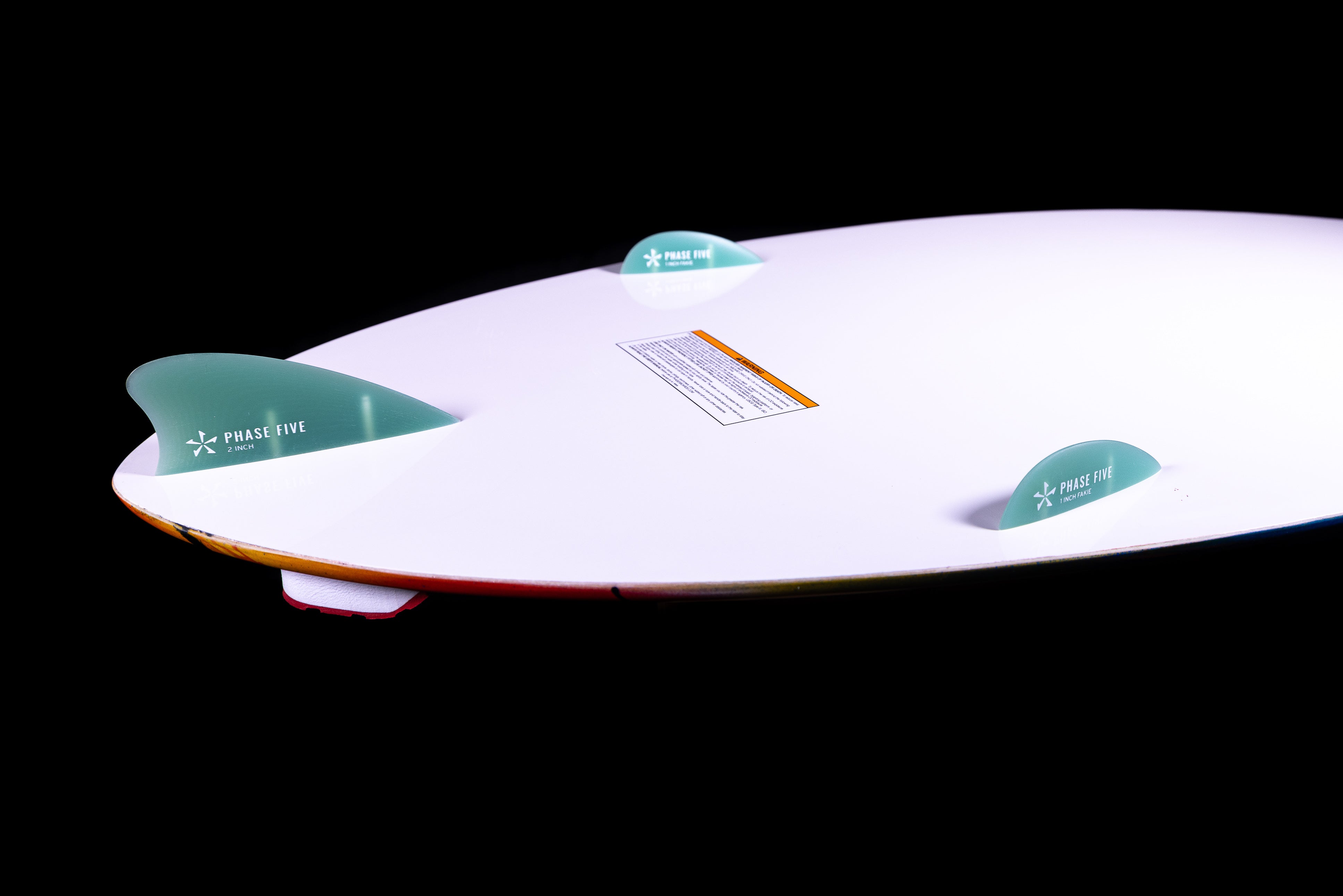 2025 Phase 5 Scamp skim board featuring a sleek white surface and two green fins for enhanced performance.