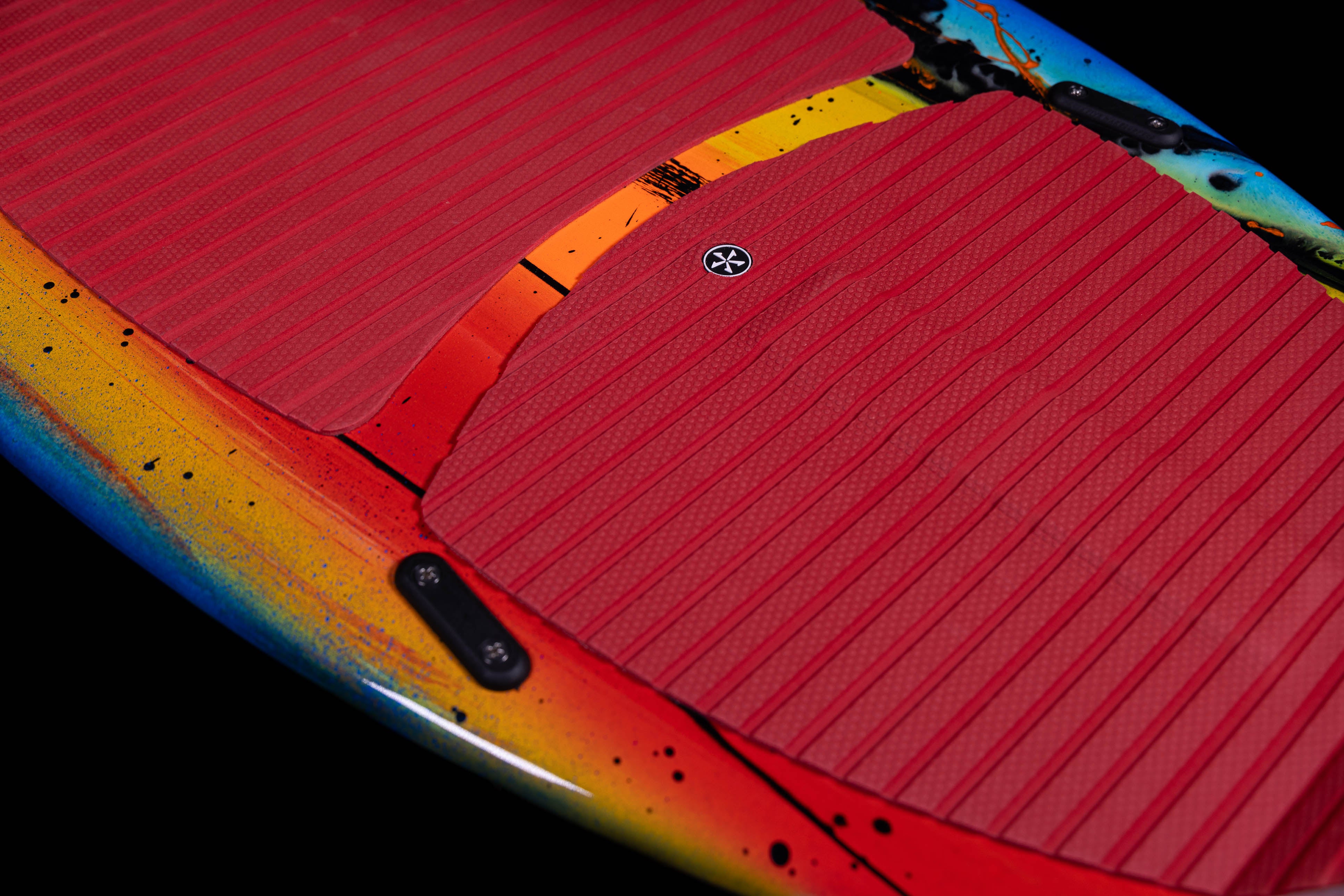 Close-up of the 2025 Phase 5 Scamp skim board featuring a vibrant design and textured grip pads for enhanced traction.