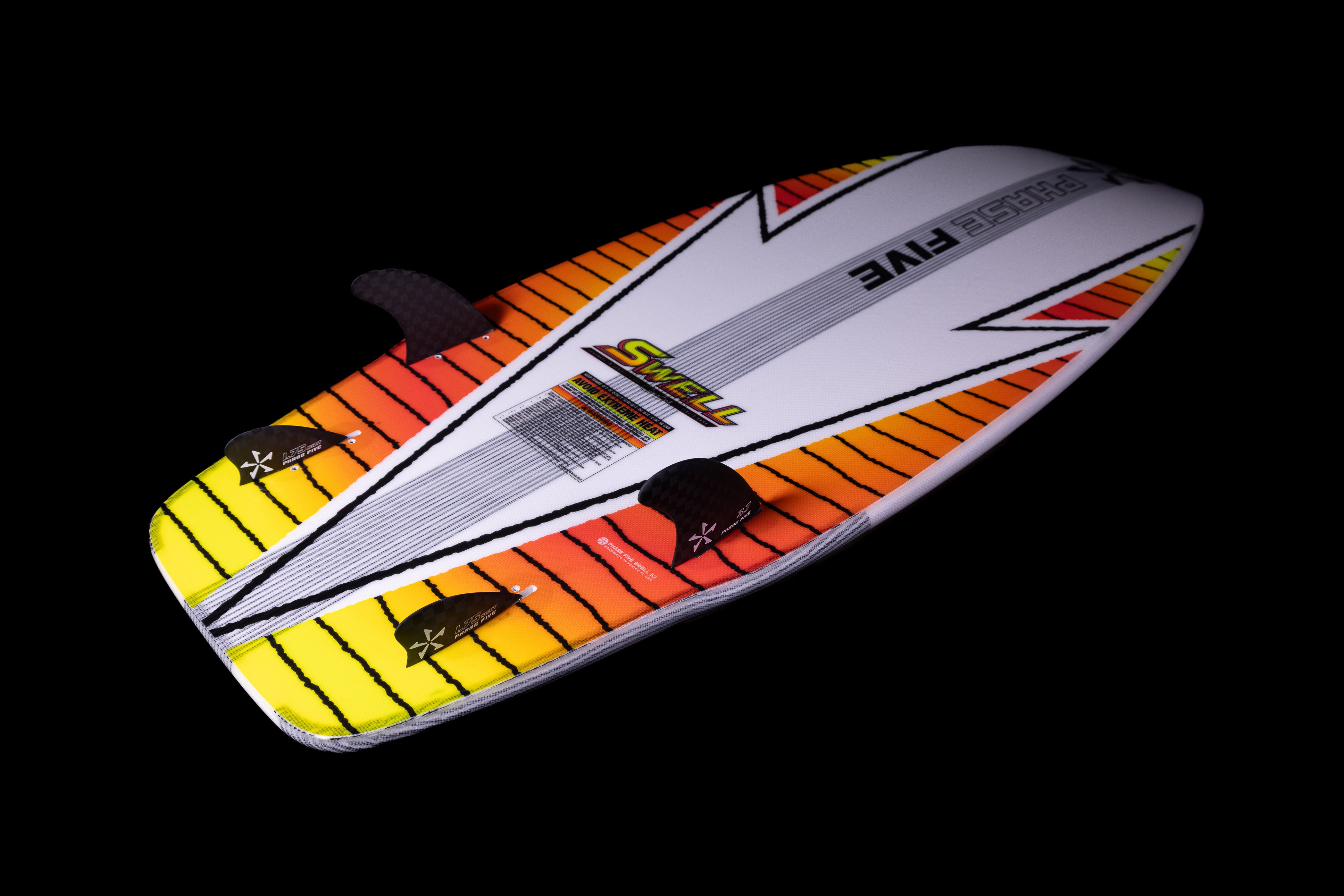 Colorful 2025 Phase 5 Swell Surf Board with vibrant orange, yellow, and white design, featuring fins and grip pads.