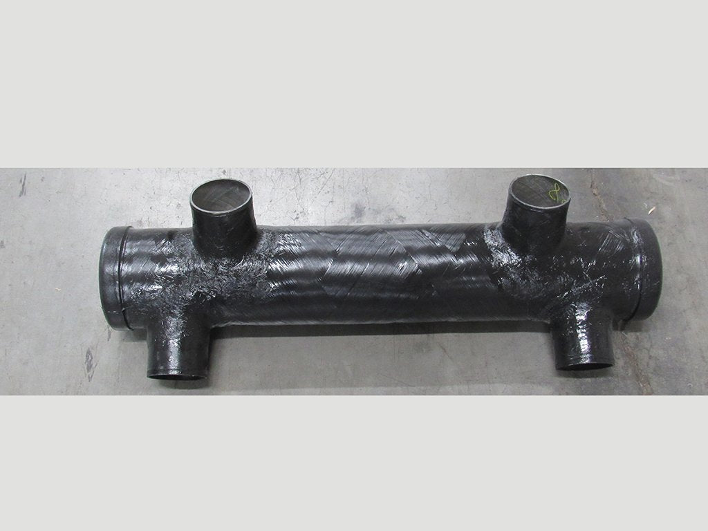 Black metal muffler with four openings, designed for vehicle exhaust system, measuring approximately 12-15 inches in length.