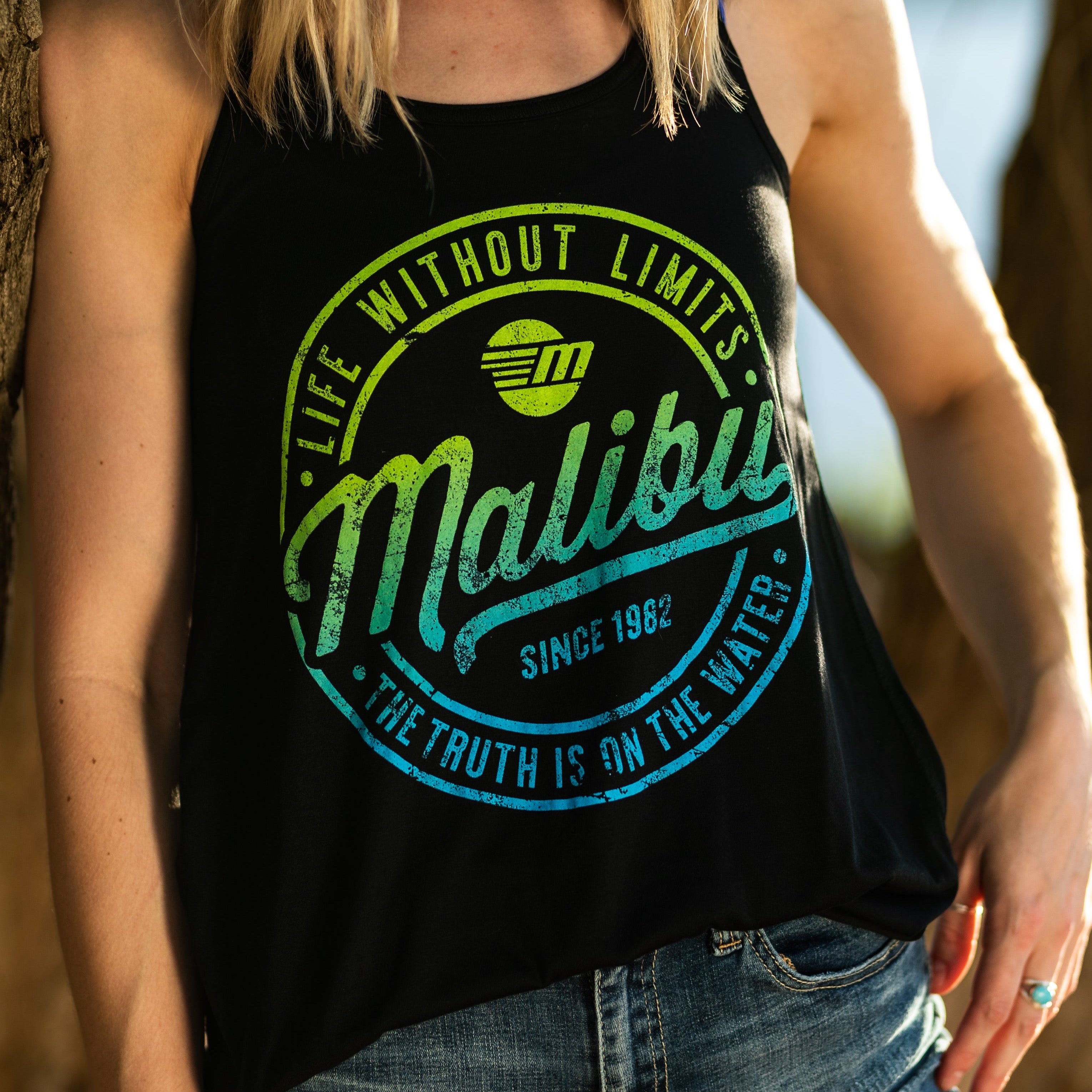 Women's black tank top with a colorful Malibu logo and text, featuring a sleeveless design and casual fit.