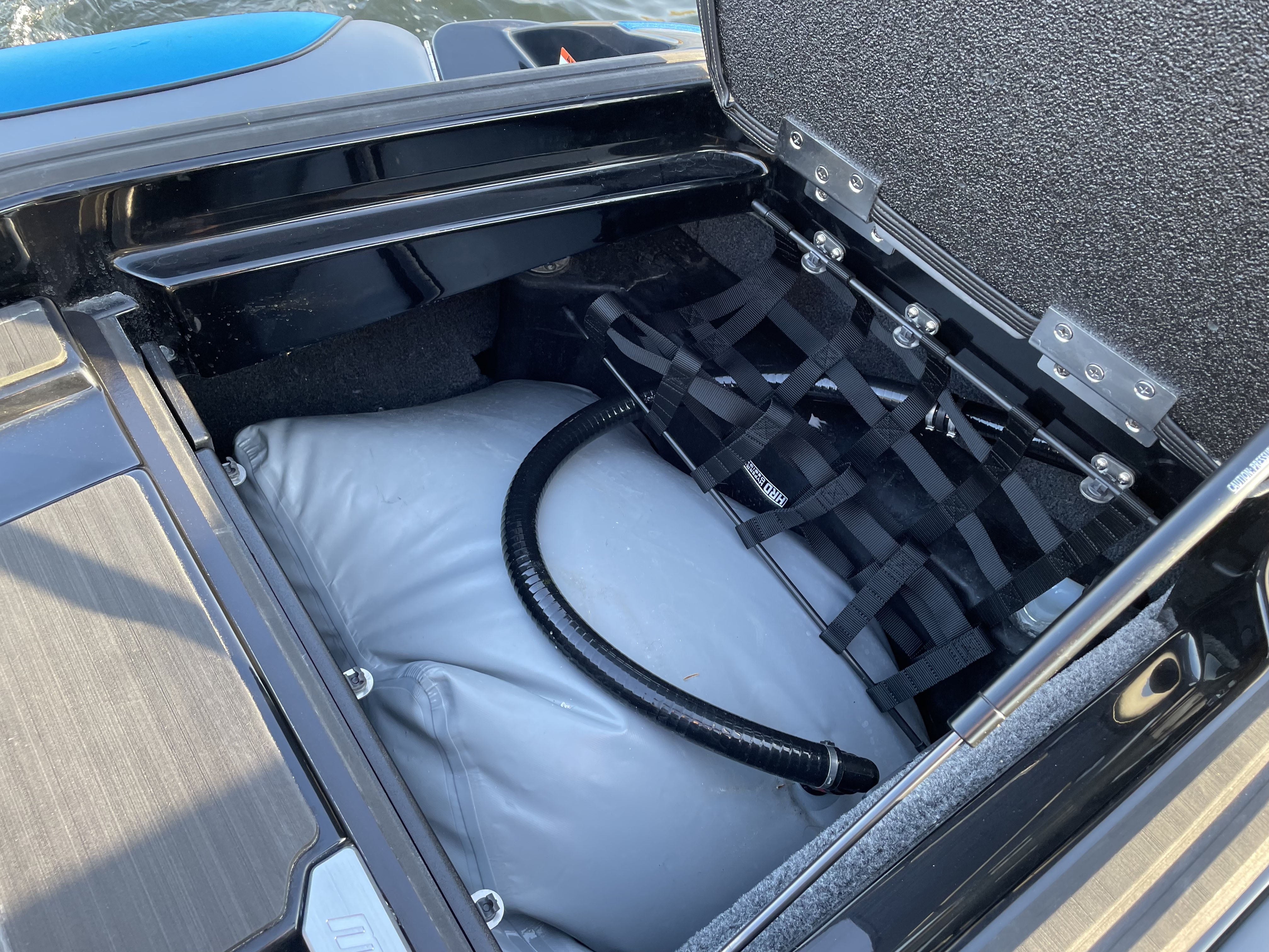 Pair of HRD Locker Nets installed inside a vehicle's storage compartment, featuring black straps and a secured gas cylinder.