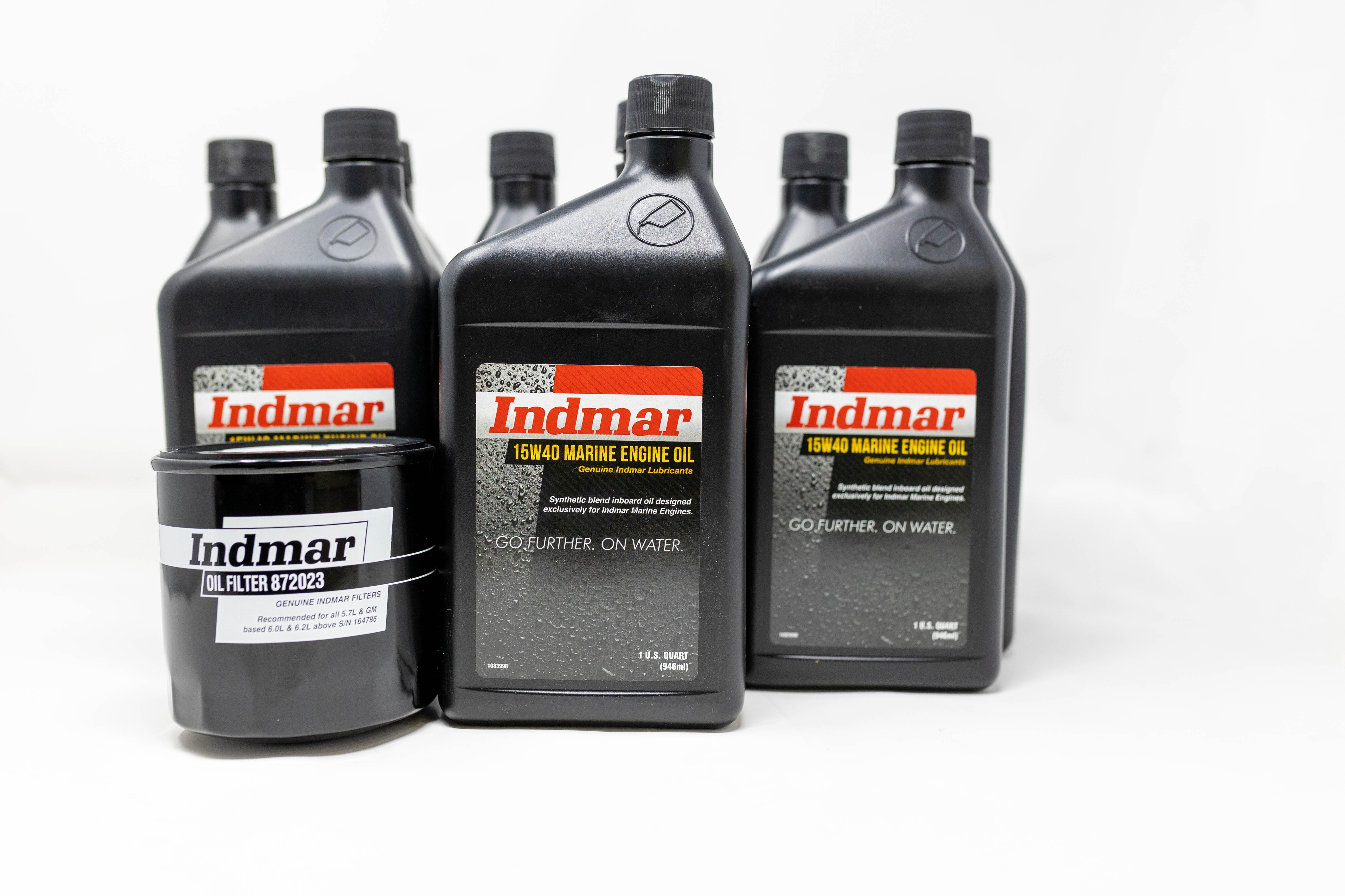Set of Indmar oil service kit including engine oil bottles and a filter, designed for marine engines, with black containers and labels.
