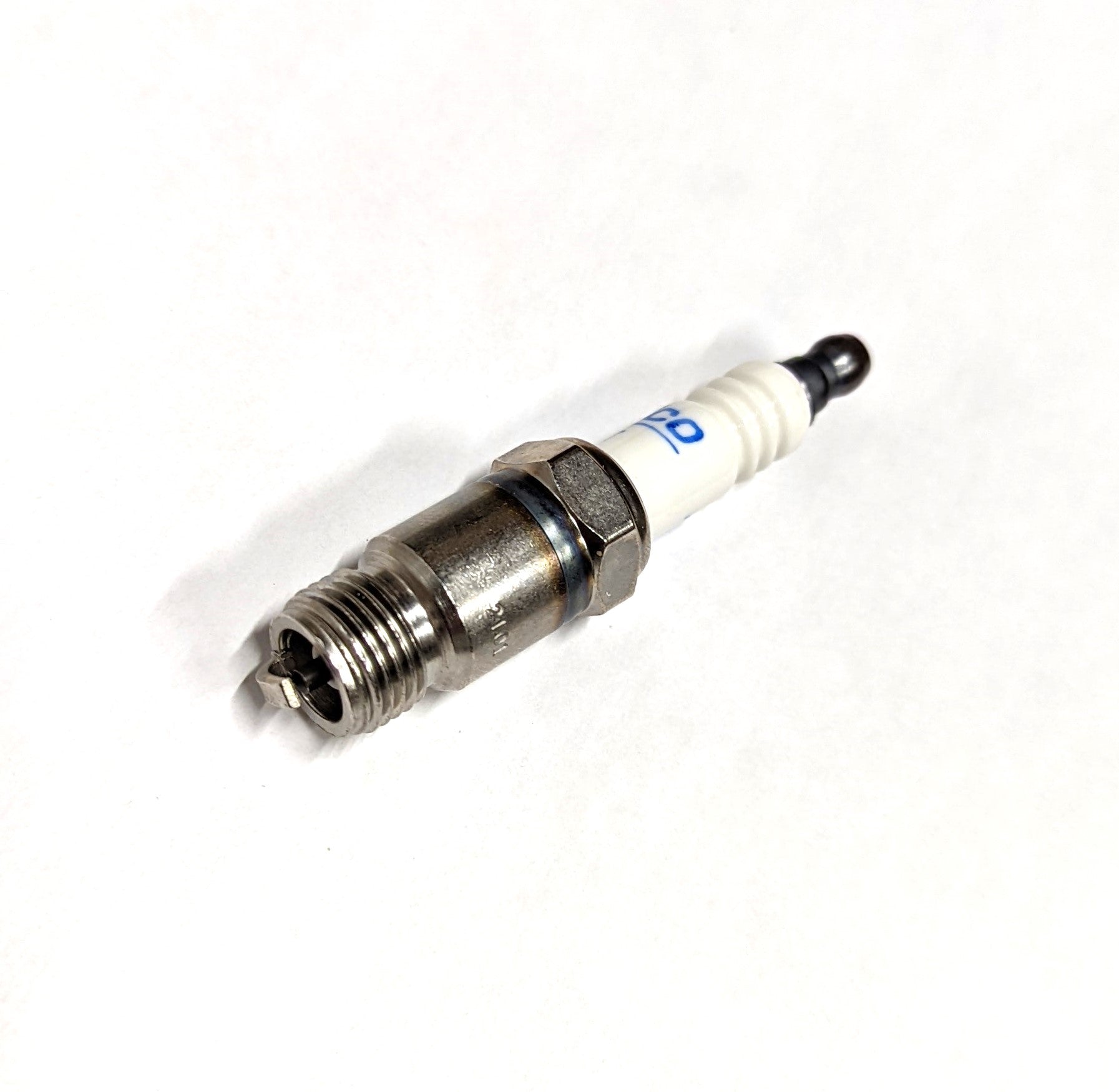 Spark plug for Indmar 5.7 Pre-Vortec engine, with metal threading and white ceramic insulator.