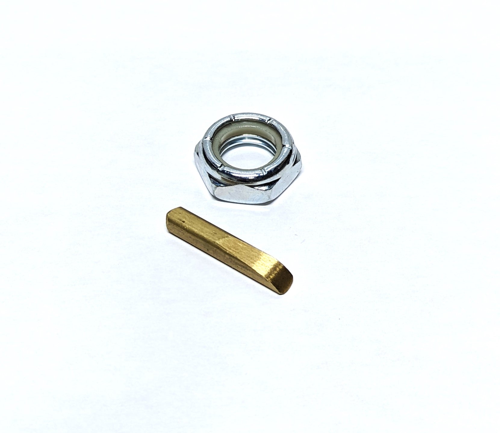 Metal shaft coupler nut and key kit for 1-inch shafts, including a hex nut and a brass key, used for mechanical connections.