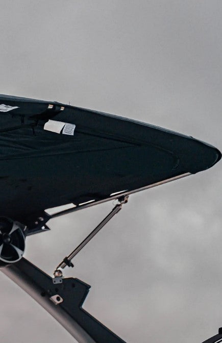Pull pin-bimini support pole attached to boat's canopy for quick deployment and stability.