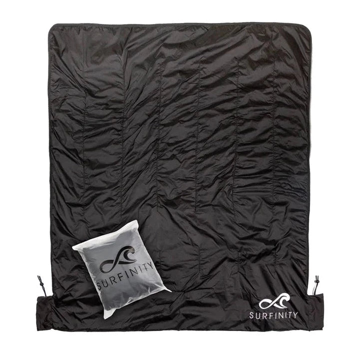Heated boat blanket by Surfinity with a black, insulated surface and a small white carrying pouch featuring the Surfinity logo.