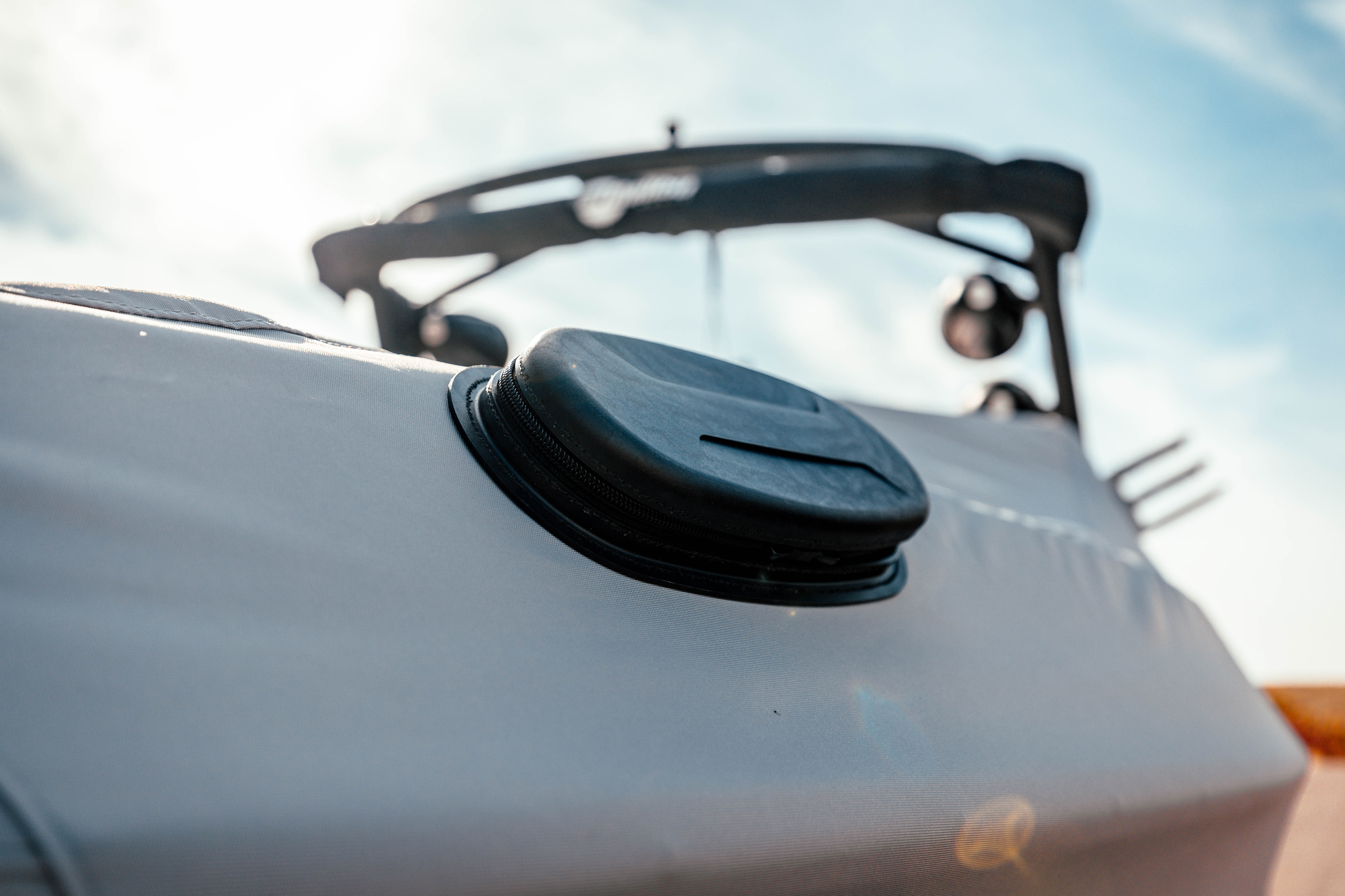 Close-up of a 23 LSV cover with bow cleats on a G3 tower boat, showing the black cover secured on the boat's surface.