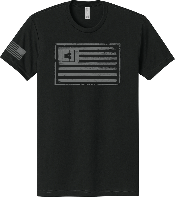 Black T-shirt with a distressed American flag patch on the sleeve and a gray, grunge-style American flag graphic on the front.