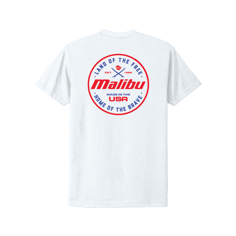 White Malibu Brave Tee featuring a circular red and blue design with "Land of the Free" and "Home of the Brave" text on the back.