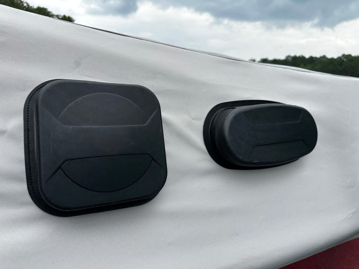 Black A24 FatAX Tower cover and case mounted on a white surface outdoors under cloudy sky.