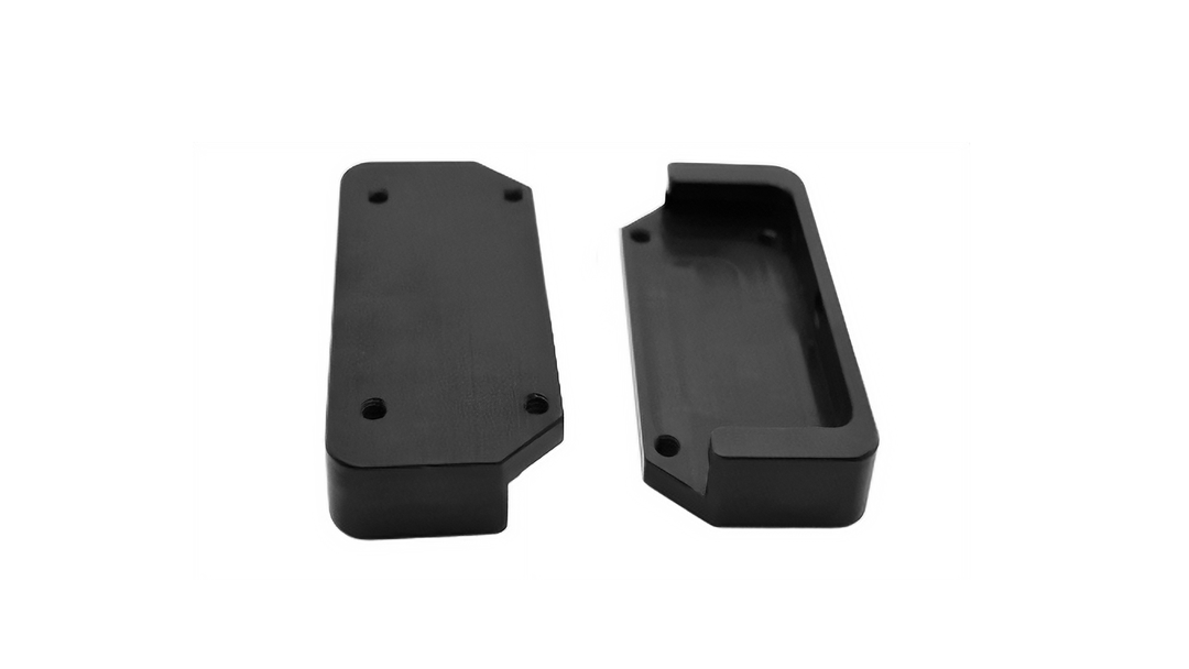Black Malibu G3 Bimini Receiver components, one with mounting holes and the other with a recessed interior.