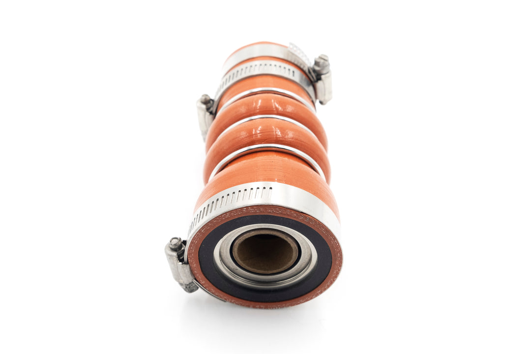 A close-up of an orange industrial shaft seal with metal clamps, designed to prevent fluid leakage along rotating shafts.