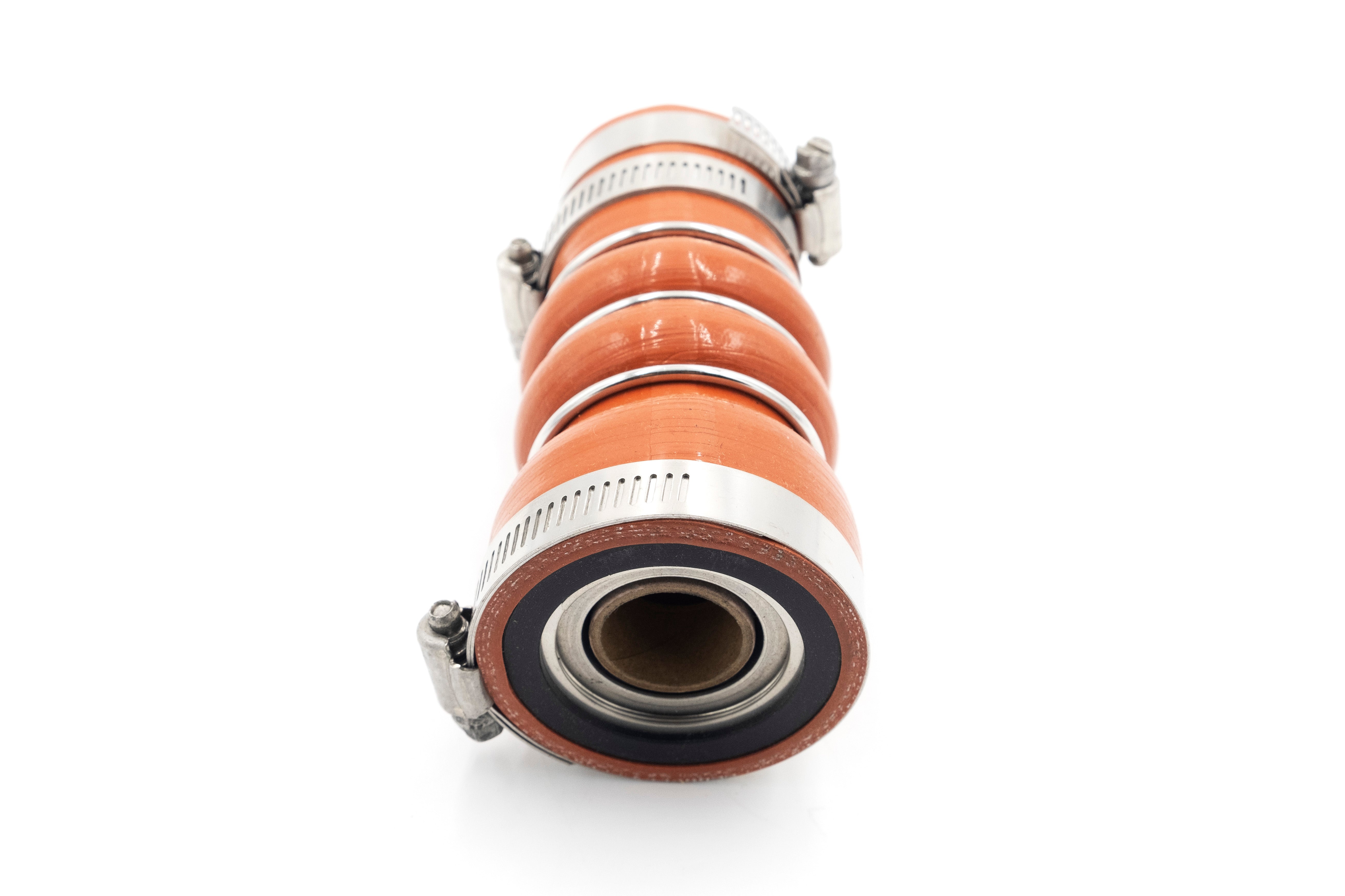 A close-up of an orange industrial shaft seal with metal clamps, designed to prevent fluid leakage along rotating shafts.