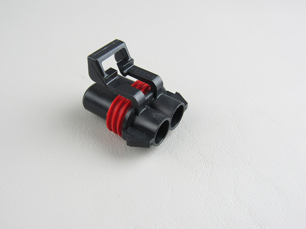 Malibu Ram Connector, Metri-Pack 480 Female Block, black plastic electrical connector with red sealing rings on a white background.