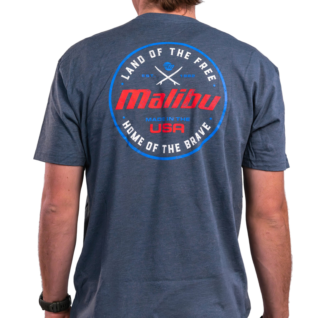 Malibu Brave Tee featuring a patriotic design with "Land of the Free" and "Home of the Brave" text on the back.