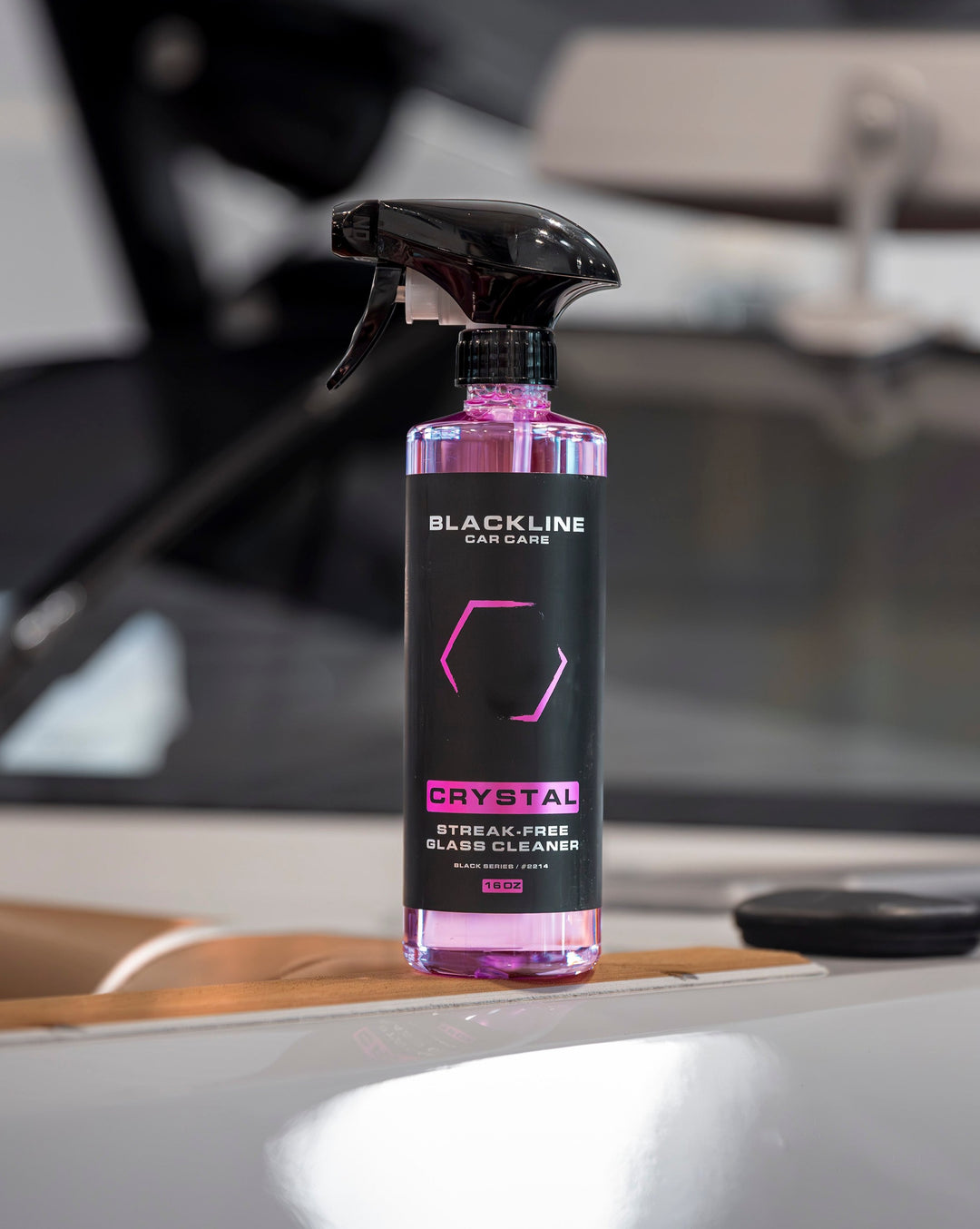 Blackline Crystal Glass Cleaner in a pink and black spray bottle, designed for streak-free cleaning of glass surfaces.