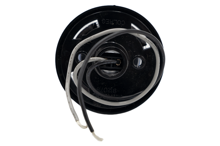 Close-up of a tower anchor light with black and white wires, used for aviation or maritime navigation.
