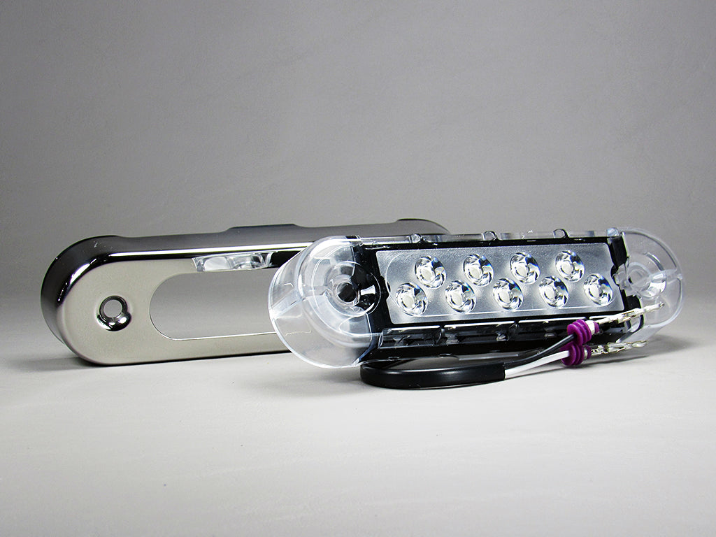 Alt text: "15 Malibu underwater light in blue, featuring a chrome body and a clear lens with multiple LED bulbs visible. The light is shown with wiring exposed, indicating installation readiness."