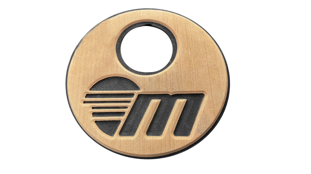 Round inspection cover with a soft grip, featuring a black and gold design and a central hole for easy handling.