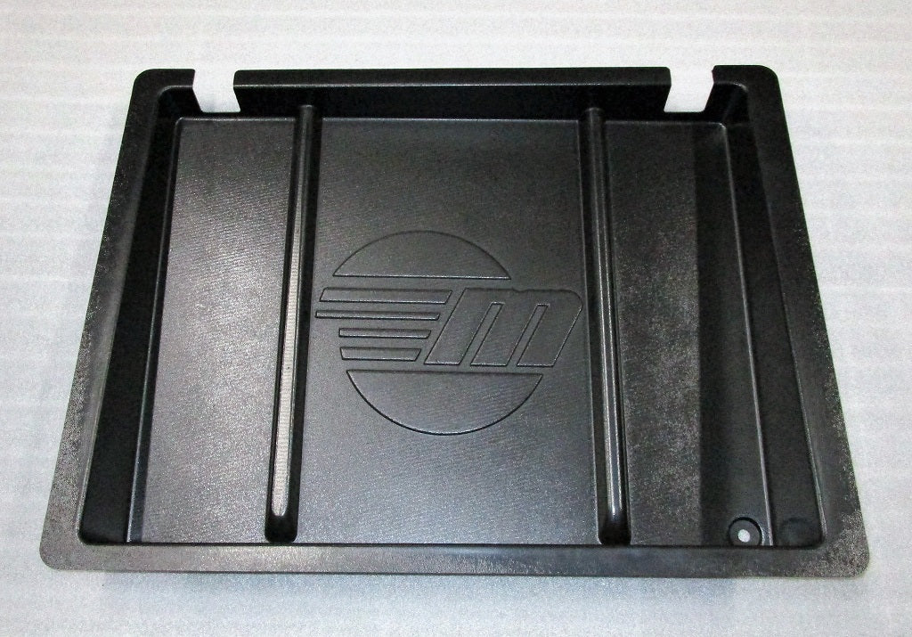 Black storage tray for motor box with VN trim change, featuring a central logo and raised edges for organization.
