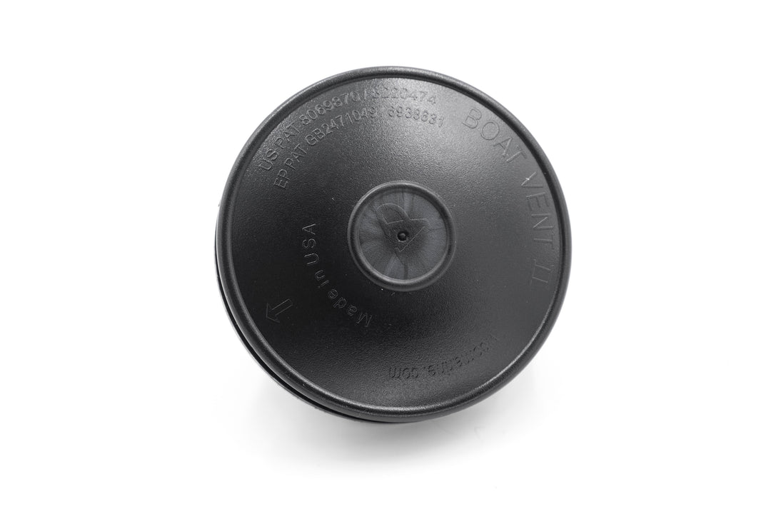 Black cover vent with embossed text, arrows, and manufacturing details, designed to fit over a vent opening.