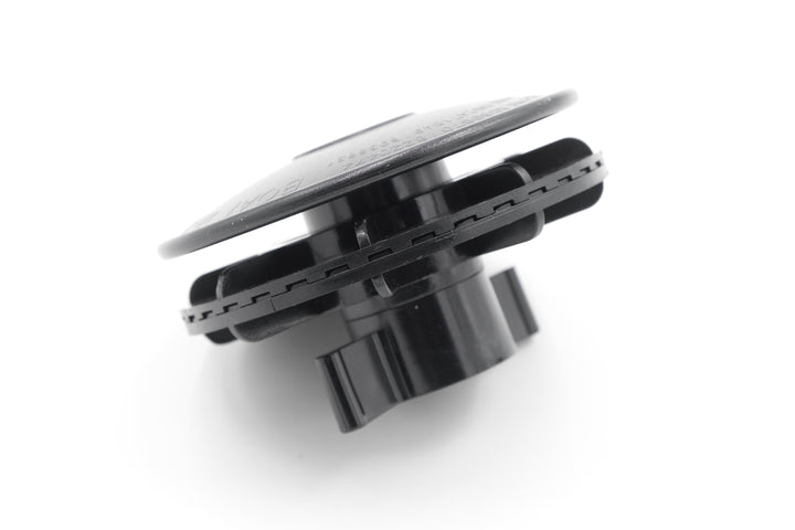 Close-up of a black cover vent with a circular design, used for ventilation or airflow regulation in appliances or systems.