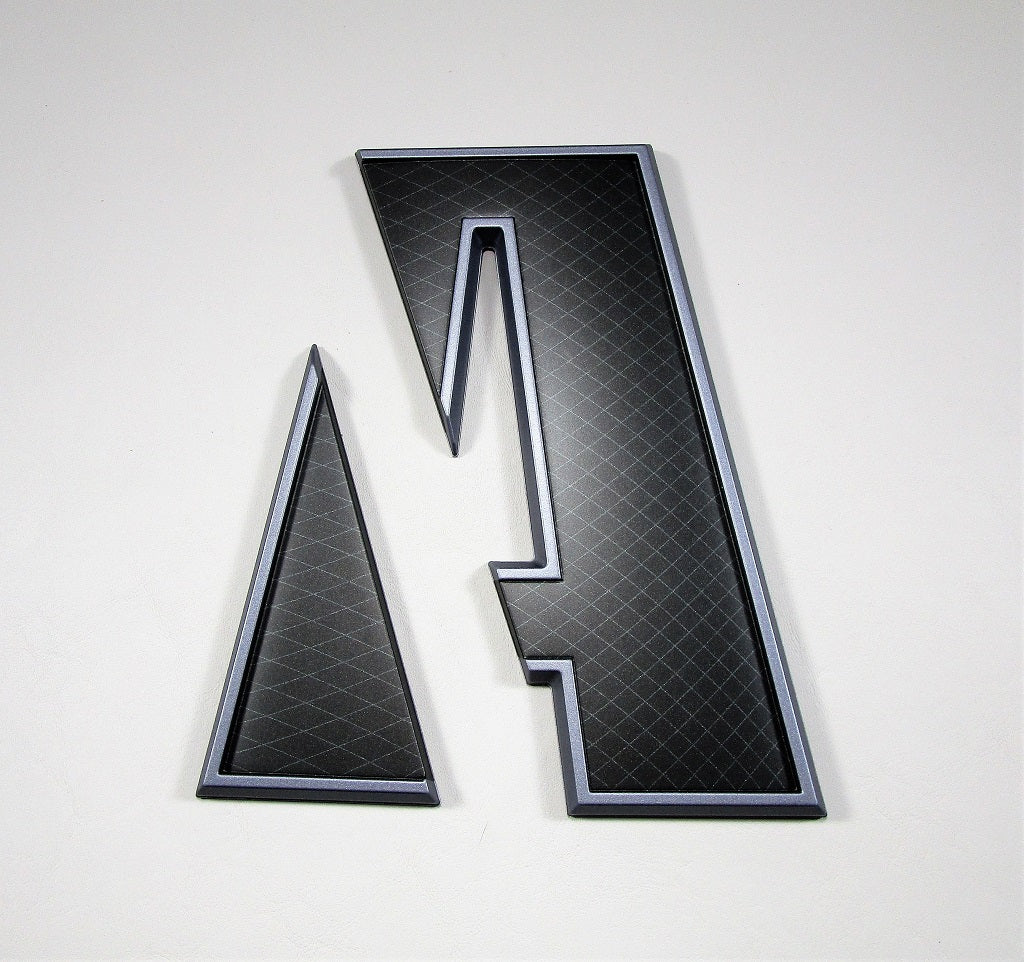 Black and silver Axis Starboard "A" emblem with a textured surface, designed for vehicle or product branding.