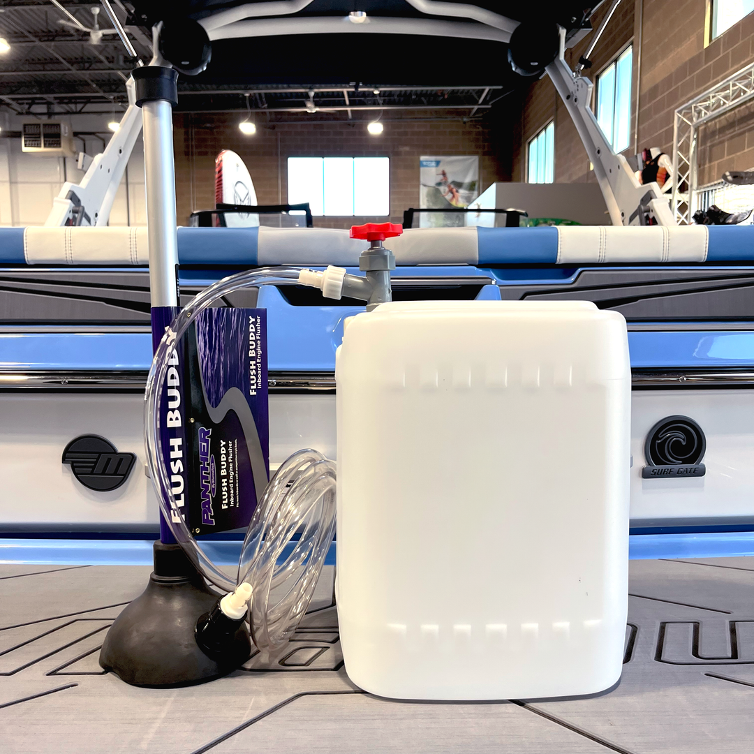 Winterizing kit for inboard boats, featuring a pump, hose, and container for effective engine protection.