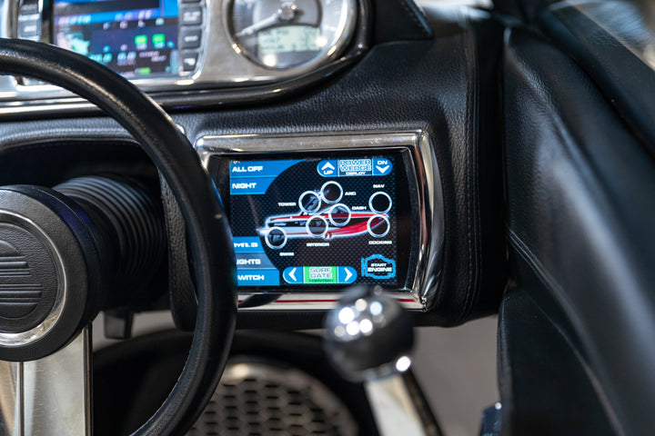 Malibu 6-1/2" touch screen display installed on a vehicle dashboard, showing various controls and digital interface.