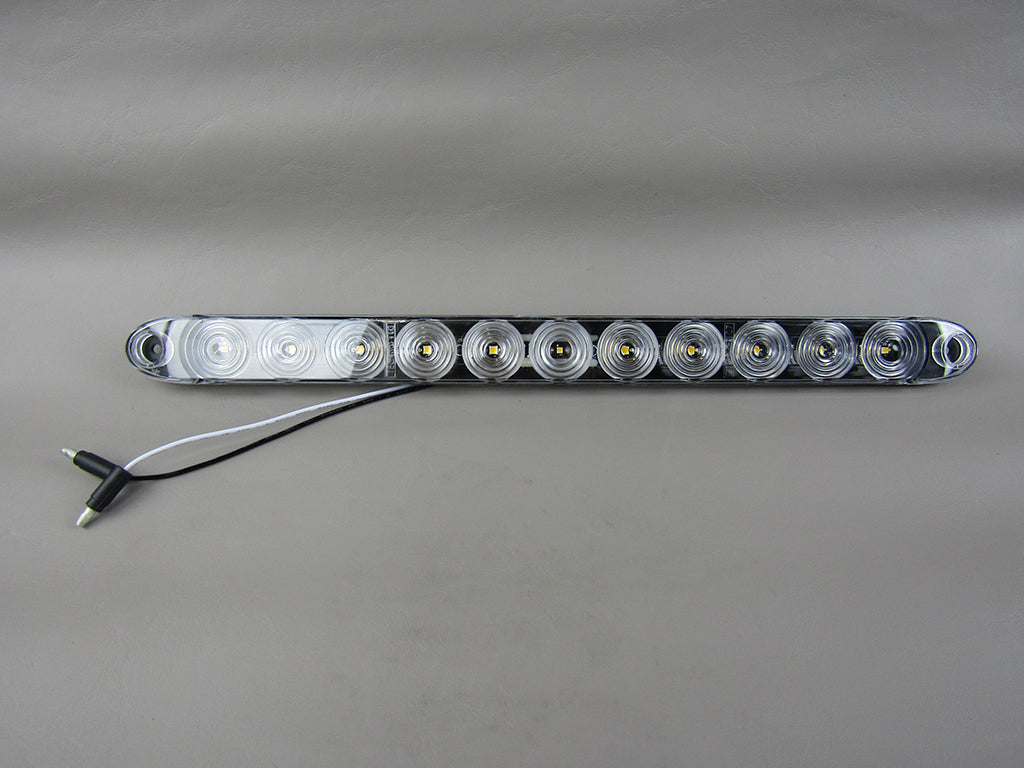 White trailer reverse light bar with multiple LED bulbs and wiring for vehicle backup illumination.