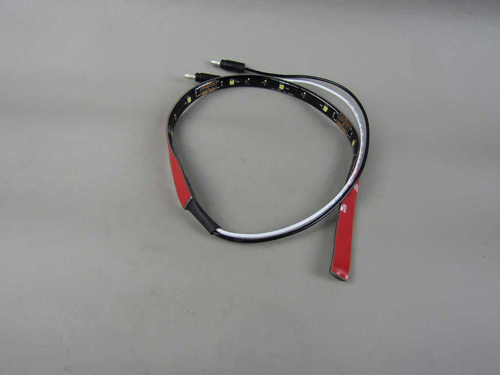 White LED flex strip lights with a black wiring connector, flexible design, and adhesive backing for easy installation.