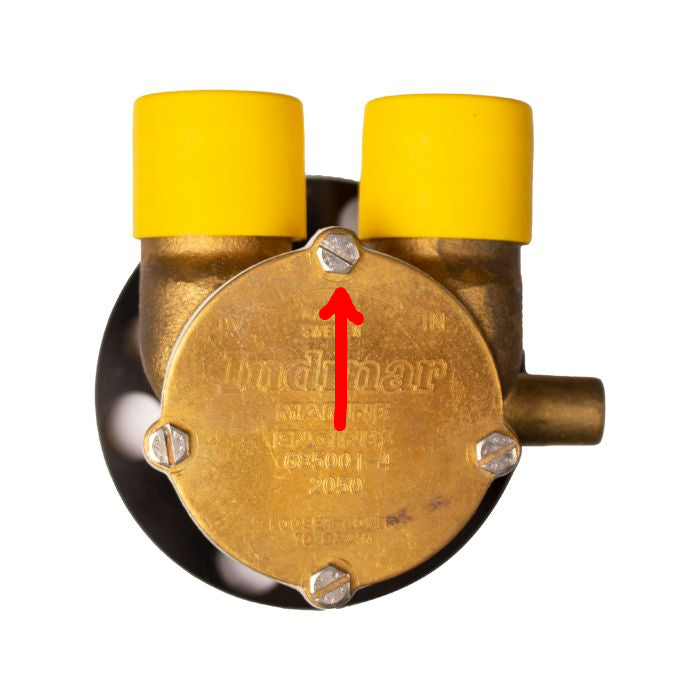 Close-up of a brass Indmar impeller housing cover with yellow screw caps and four visible screws, used in marine engines.