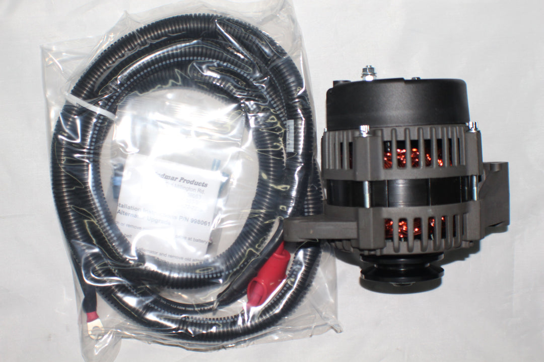 Indmar 70 AMP alternator kit with a black and gray alternator and a coiled wiring harness in clear plastic packaging.