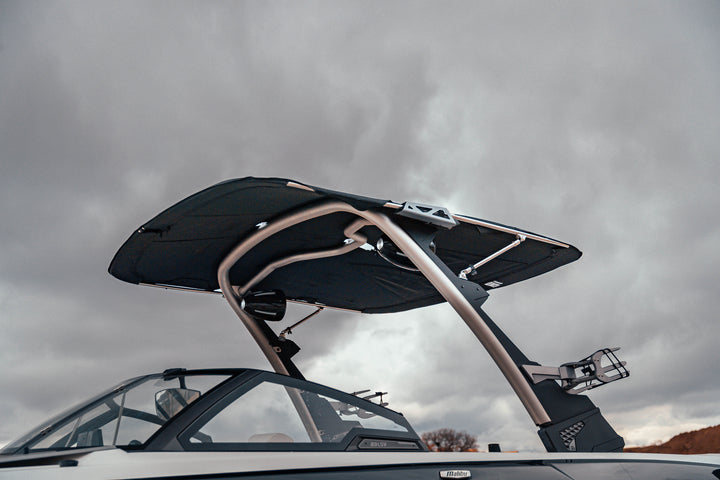 Malibu G3 boat with a large black bimini canvas and boot, installed on the boat&
