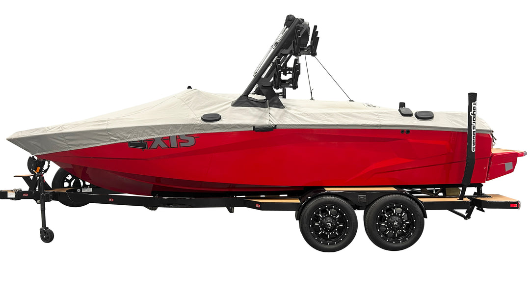Red and white Axis AW20 boat with a tower, swim platform cover, and TAPS 2.5 system, mounted on a dual-axle trailer.