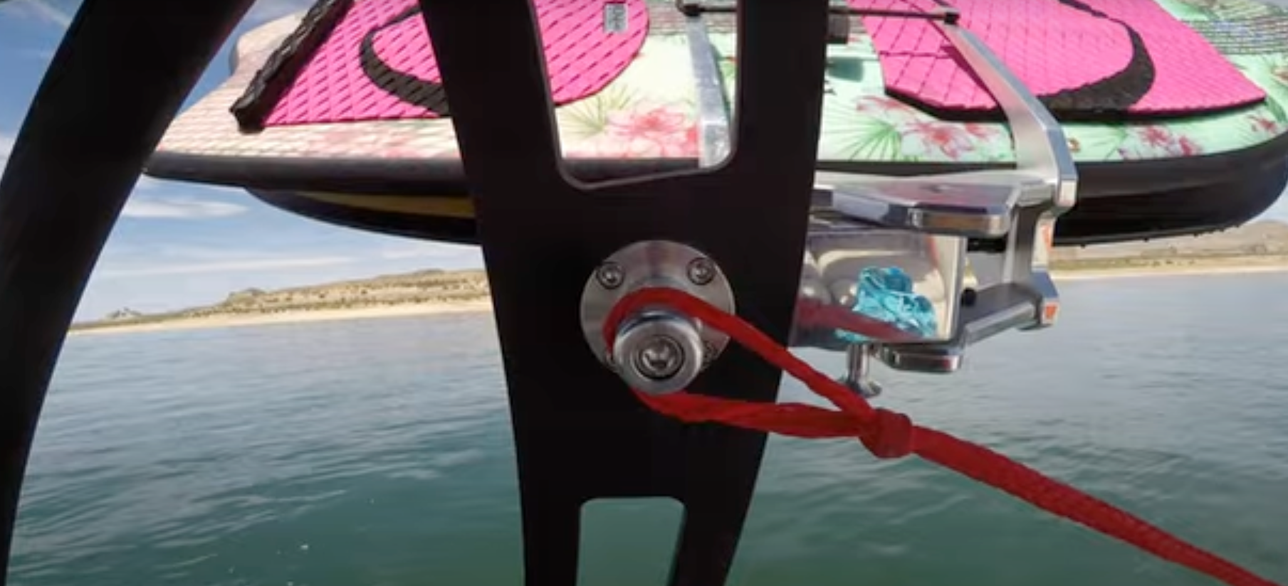 Close-up of Axis Surf Tow Points with a red tow rope attached, mounted on a surfboard for water sports towing.