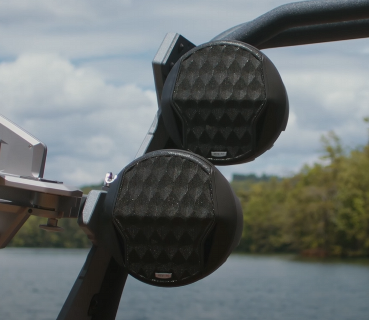 Malibu REV8 tower speakers, 22-24 inches, mounted outdoors near water, with black textured speaker grilles.