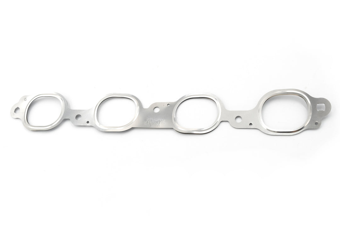 Exhaust head to manifold gasket in silver metal, designed to seal engine exhaust connections.
